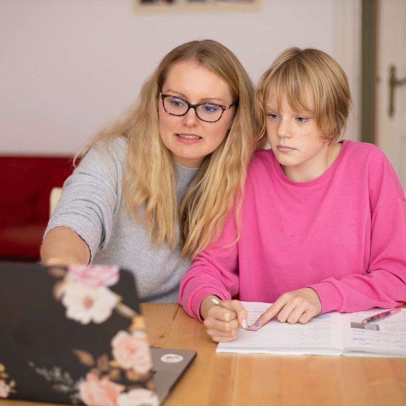 A mom helping her daughter with schoolwork at home